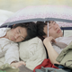 Striking Beijing university students take a midday break with an umbrella to protect themselves from the heat.